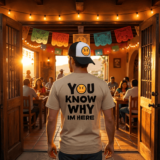 Person wearing a cap and t-shirt with text in a warm, inviting restaurant setting